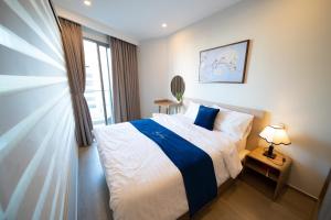 a bedroom with a bed and a window at Luxury The Song Vung Tau Apartment Homestay in Vung Tau
