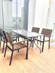 a table and chairs in a room with a window at 2 BR with city view near Subway in central in Singapore