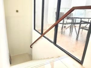 a view of a staircase from a room with a window at 2 BR with city view near Subway in central in Singapore
