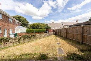 a yard with a fence and a house at Luke Stays Hill Crest Esh Durham in Durham