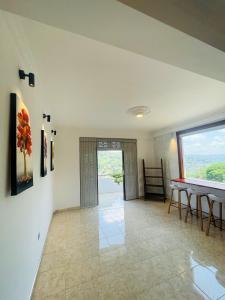 a dining room with a table and a large window at Rusty Bunk Villa in Kandy