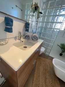 a bathroom with a sink and a toilet at Malibu Park Apartments Sol in Adeje