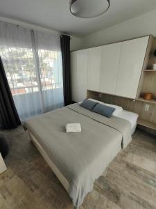 a bedroom with a large bed and a large window at Malibu Park Apartments Sol in Adeje