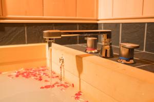 a sink with water coming out of a faucet at 喜楽・里桜 in Kyoto