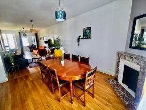 - un salon avec une table en bois et une cheminée dans l'établissement Frida- Nancy Thermal à 2 min- 10 pers - chez Julie, à Nancy