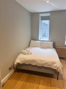 a small bedroom with a bed with a window at Union Terrace Garden View in Aberdeen