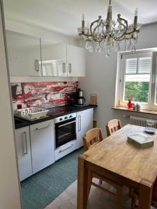 a kitchen with a table and a dining room at Ferienwohnung Christine am Weissenbach in Strobl