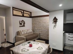 een woonkamer met een tafel en een bank bij Il Rifugio in Pescasseroli