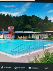 a large swimming pool in front of a building at Apartment Talblick in Kandern
