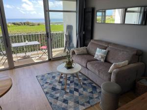 a living room with a couch and a table at Appartement Belles Vacances in Quiberon