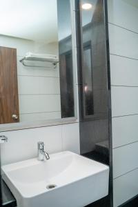 a bathroom with a white sink and a mirror at Hotel Dreamland in Pune