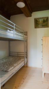 a bedroom with two bunk beds in a room at Chalupa přehrada Fojtka in Mníšek