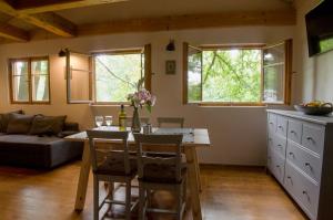 a kitchen and dining room with a table and chairs at Chalupa přehrada Fojtka in Mníšek