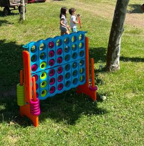 two children playing with a large board game in a park at Camping Paxariñas in Portonovo