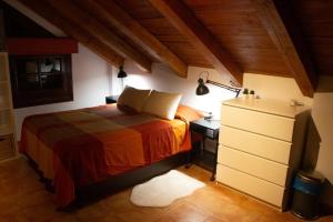 a bedroom with a bed and a desk with a lamp at Buhardilla Cortijo Pontiví in Salobreña