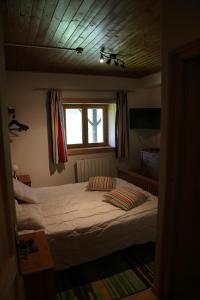 a bed in a bedroom with a window at CHALET ELISTHUR in Saint-Jean-d'Aulps