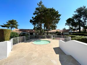 a small pool in a patio with a fence at L'évasion des pins - Au coeur de la Nature in Saint-Jean-de-Monts