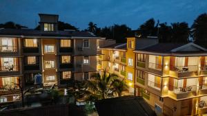 a group of apartment buildings at night at Kay's Calangute Resort Service Apartments in Calangute