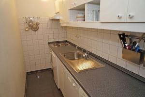 a kitchen with a sink and a counter top at Penthousewohnung vor der Promenade in Damp