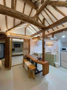 a kitchen with a wooden table in a room at Bow Hanok House in Gangneung