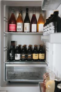 a refrigerator filled with lots of bottles of beer at Pañ boetiek BnB in Zele