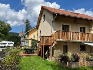 a house with a deck on the side of it at Gîte les Pervenches avec Sauna in Gérardmer