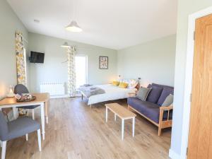 a living room with a couch and a table at The Wheelhouse in Carinish