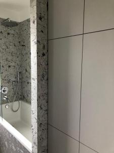 a bathroom with a shower and a bath tub at Komfort & Wodna Dolina in Koszalin