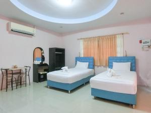 Ban Thung Sam SaoにあるAURA Park Resortのテーブルとデスクが備わる客室内のベッド2台