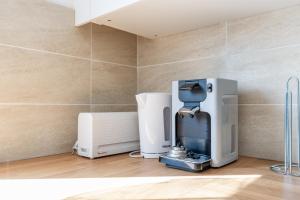 a coffee machine in a room with a wall at BIG BEN Near Disneyland Paris - Fairytale Factory in Bussy-Saint-Georges +16 photos