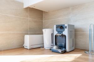 a coffee machine in a room with a wall at BIG BEN Near Disneyland Paris - Fairytale Factory in Bussy-Saint-Georges