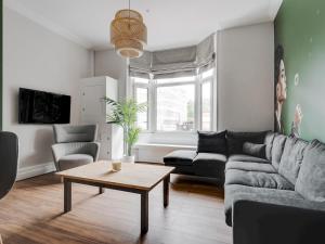 a living room with a couch and a coffee table at Pass the Keys Stylish Aigburth Flat Sleeps 12 in Liverpool