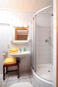 a bathroom with a sink and a shower at Haus Schmölz Ferienwohnung Allgäu in Hopferau