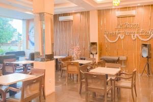 a dining room with tables and chairs in a restaurant at Urbanview Hotel Grand Permata In Banjarbaru by RedDoorz in Ulin