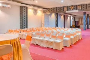 an empty banquet hall with white chairs and tables at Urbanview Hotel Grand Permata In Banjarbaru by RedDoorz in Ulin