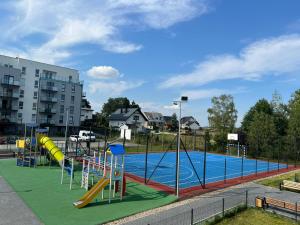 a playground with a pool with a slide and slidesktop at Apartament U Wujka Żukowo in Żukowo