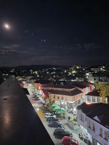 a city at night with cars parked in a parking lot at Bojana Apartment Penthouse in Negotino