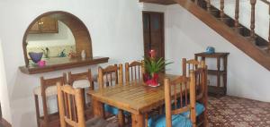 a dining room with a wooden table and chairs at Loft familial cosy in Guanajuato