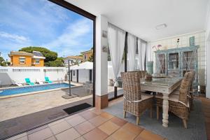 a patio with a table and chairs and a pool at Casa Anna in Novo Sancti Petri