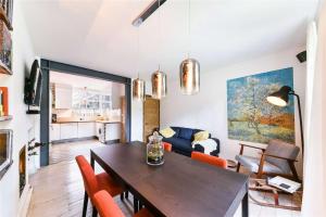 a living room with a wooden table and chairs at Designer Flat in Bethnal Green in London