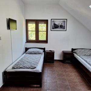 Habitación con 2 camas y ventana en Eko Dom Eturia, en Suchoraba