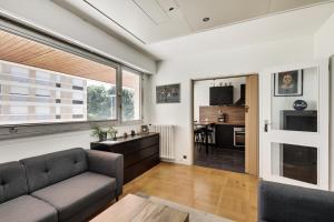 a living room with a couch and a table at Le Nid- Garches in Garches