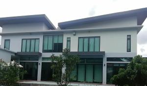 a white building with glass doors and trees at AP HOUSE in Bangkok