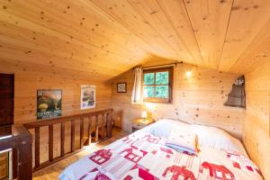 a bedroom of a log cabin with a bed at Chalet du Brey - Avec terrasse et jardin in Saint-Gervais-les-Bains