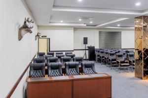 a conference room with a row of chairs and a podium at The Crest Lodge Limited in Lusaka