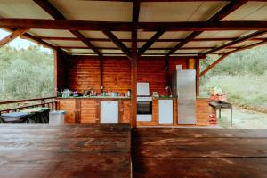 an outdoor kitchen in a log cabin with a table at LJUBAC GLAMPING BELL TENT Robinson in Ljubač +61 photos