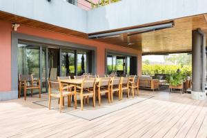 patio con tavolo da pranzo e sedie in legno di Casa de lujo junto al Club Golf a Tacoronte