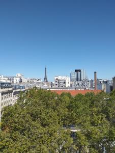 a view of a city skyline with the eiffel tower at VOLONTAIRES EIFFEL TOWER PARIS in Paris