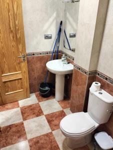 a bathroom with a toilet and a sink at Apartamentos La Calilla Cabo de Gata in El Cabo de Gata