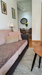 a living room with a couch and a table at Apartman Miss T in Podgorica